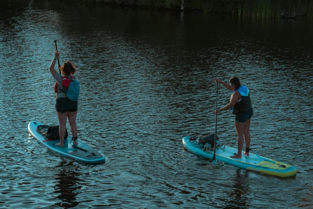 Fun exercises for weight loss - women stand up paddle boarding